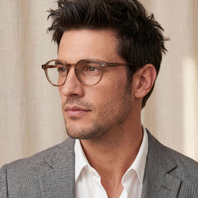 Man wearing glasses and a gray suit CARFIA Finco FC04 – Classic Round Acetate Eyeglasses in Brown