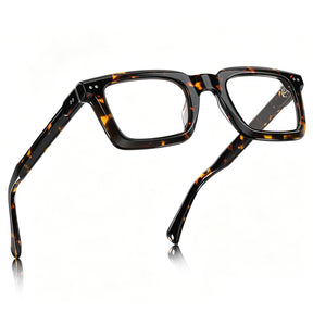 Faux tortoiseshell eyeglass frames with a glossy black and amber-brown pattern